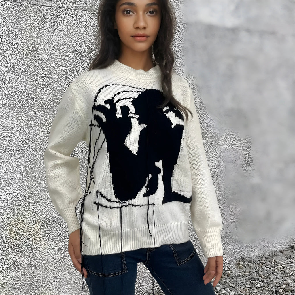 Grey women's alpaca wool pullover sweater with abstract pattern and tassel detailing on a hanger.