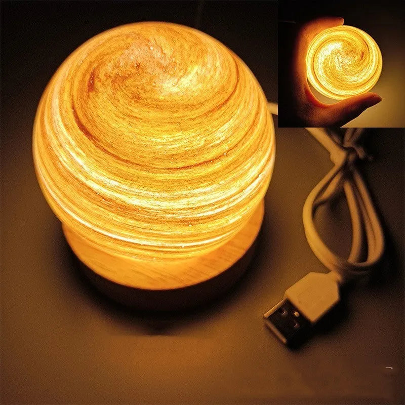 Planets themed USB night light with modern design and three-colour dimming on bedside table.