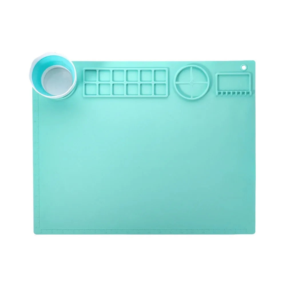 Green silicone painting mat measuring 50 by 40 centimetres with two round bowl wells for holding water or paint.