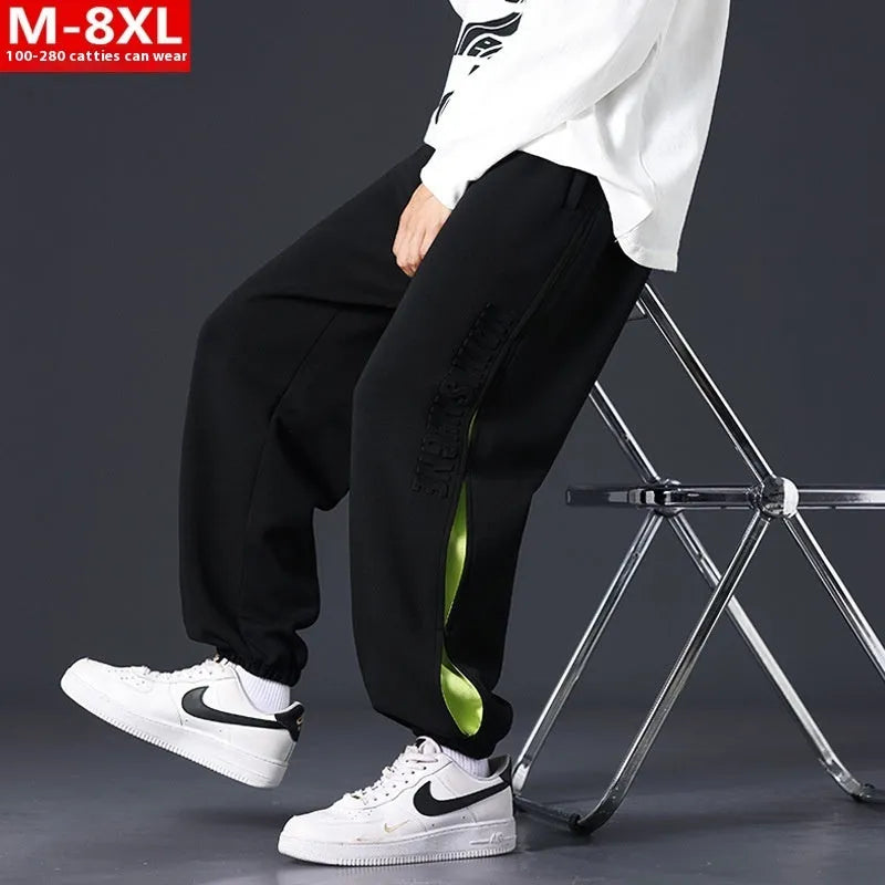 Men's loose fit cotton trousers with banded ankles and stitching details in grey green colour