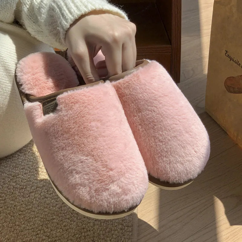Solid colour PVC winter plush house slippers with car stitching detail on a non-slip sole.