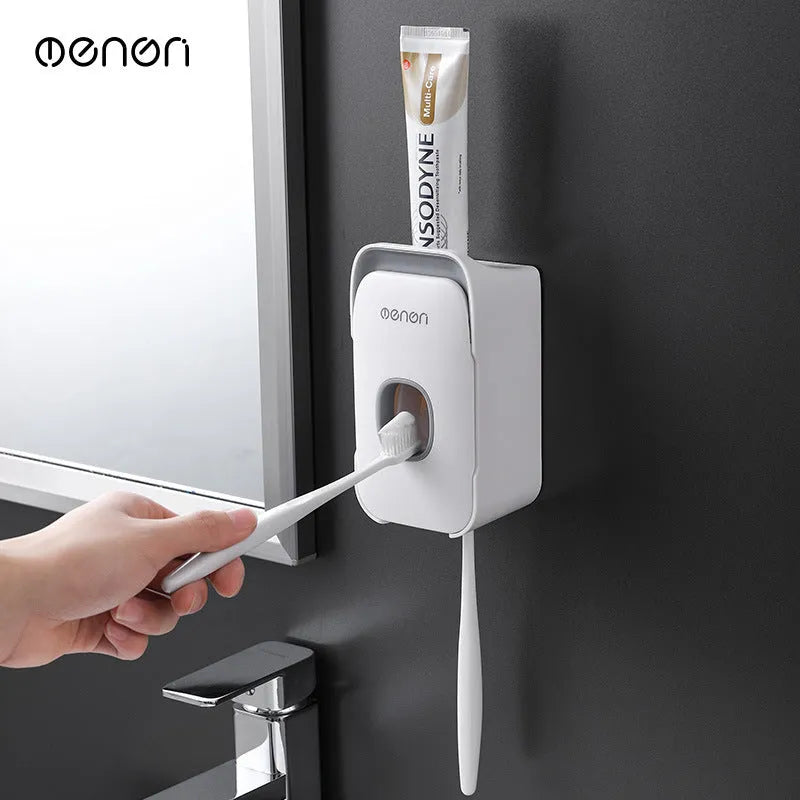 Automatic touchless toothpaste dispenser in blue colour mounted on a bathroom wall.