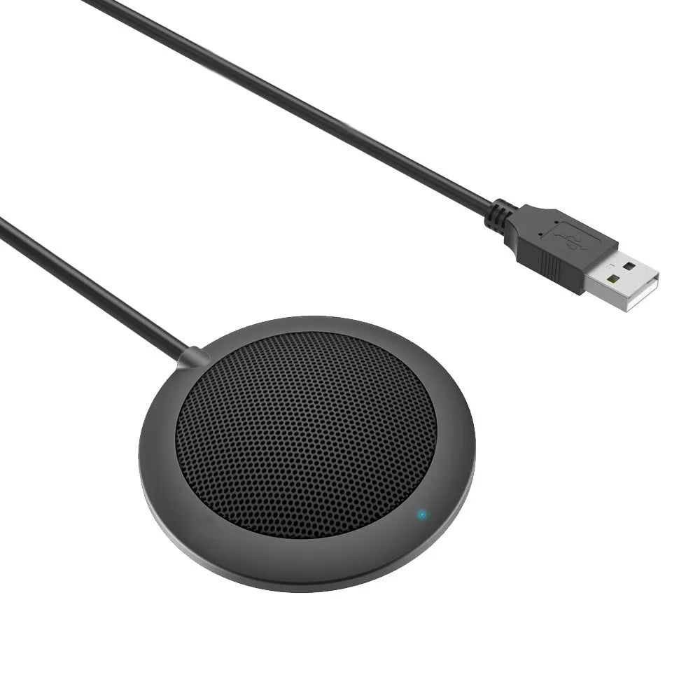 Black circular USB conference microphone with metal mesh grill on a desk