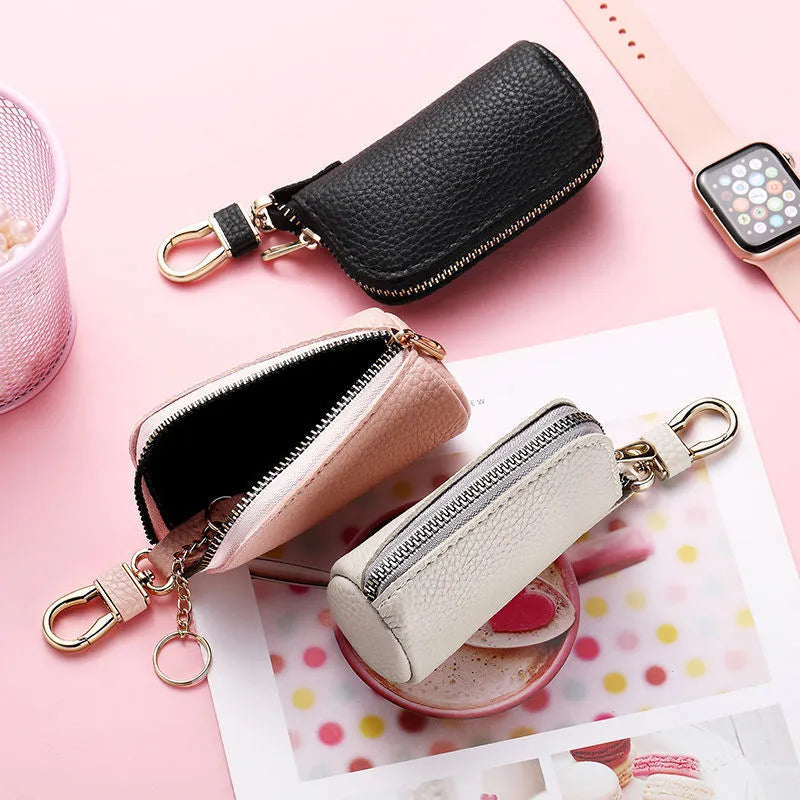 Men's black PU leather zipper key ring organiser case on a grey background.