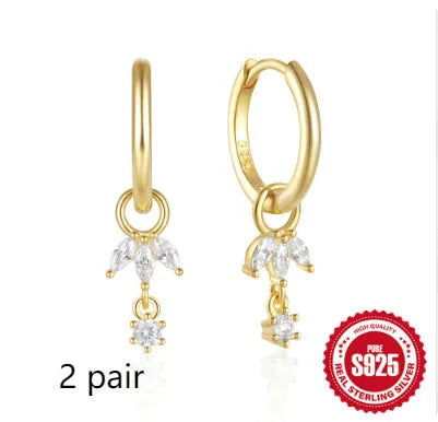 A pair of 925 sterling silver earrings with a geometric sunflower design inlaid with golden zircon stones.