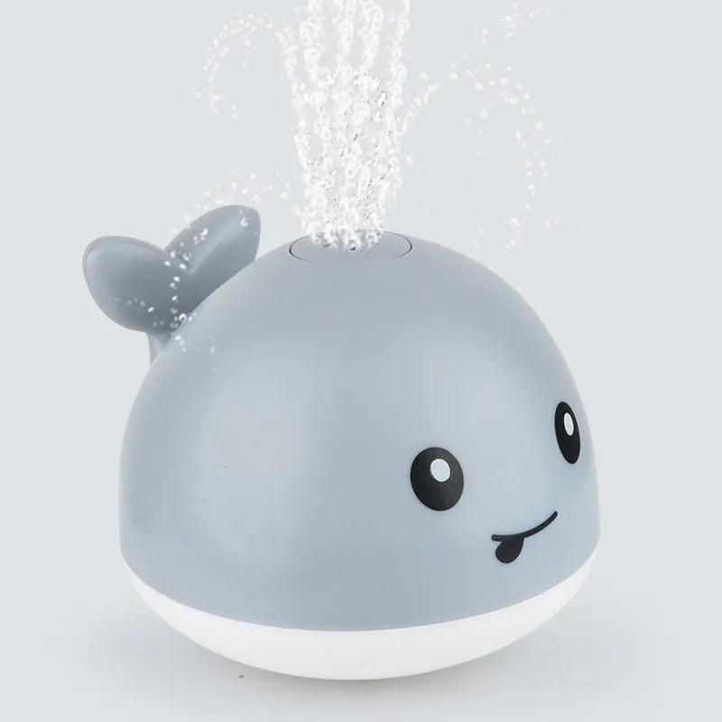 Automatic water spray whale bath toy with colourful LED lights floating in baby bath