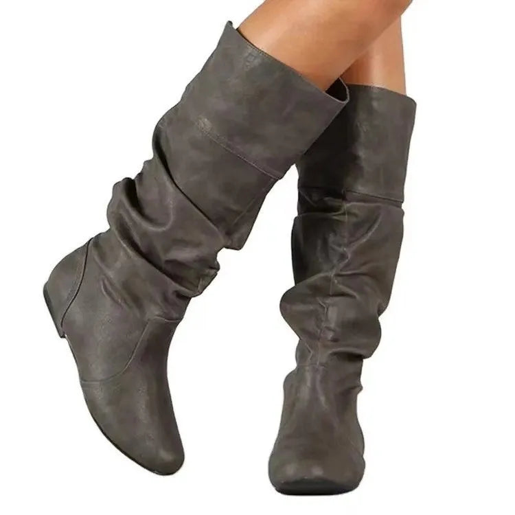 Women's black slip-on flat ankle boots with round toe and rubber sole.