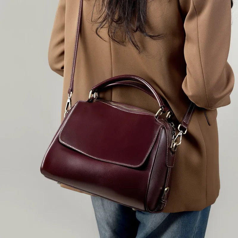 Women's soft genuine leather crossbody tote bag in a square shape with a double strap, shown in apricot colour.