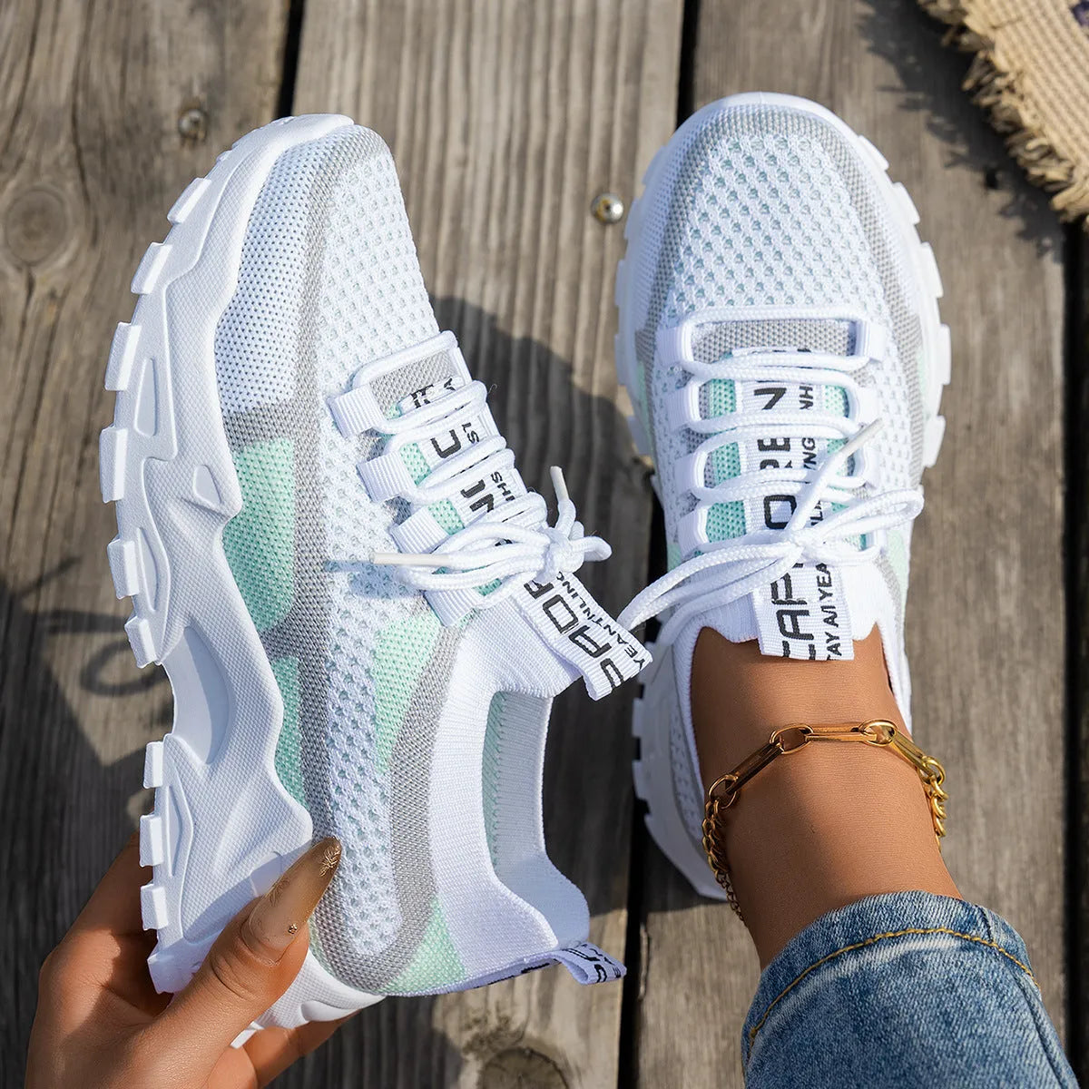 Women's Flyknit mesh lace-up sneakers in grey and white colourway