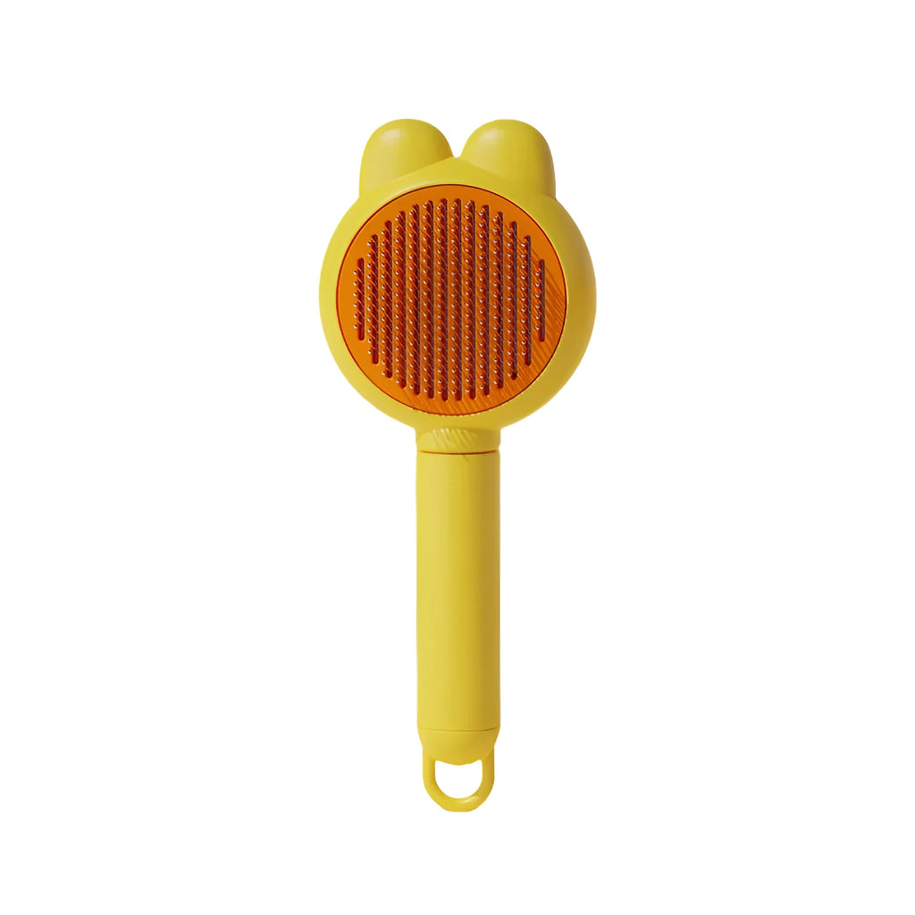 Green pet grooming brush with metal comb and release button on a non-slip handle