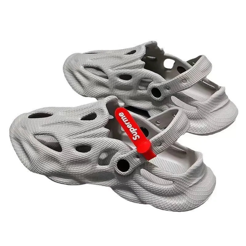 Grey closed toe EVA coconut slippers on a beach background, showing toe cap design and textured sole.