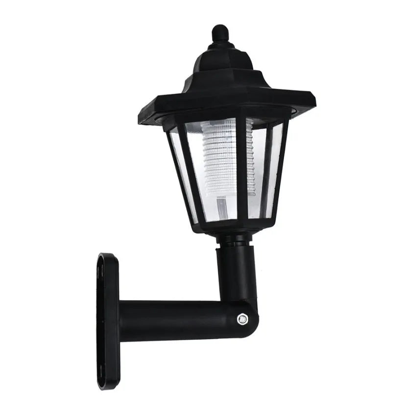 Black hexagonal solar wall lamp with light sensor mounted on an outdoor wall