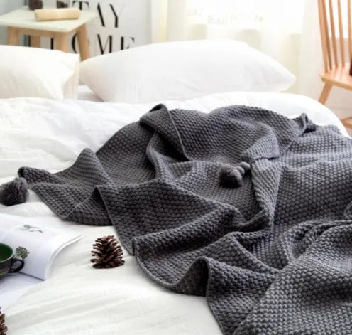 Nordic fringe knit ball blanket in beige colour on sofa, showing 130×170cm dimensions and fringe detailing.
