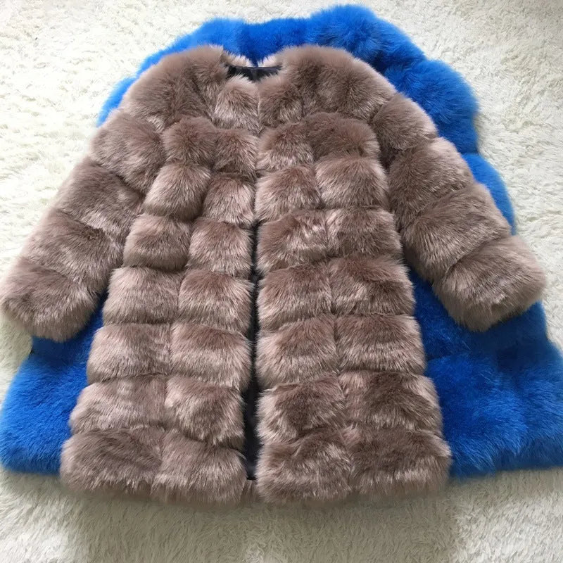 Women's long black artificial fur coat with regular sleeves on a hanger.