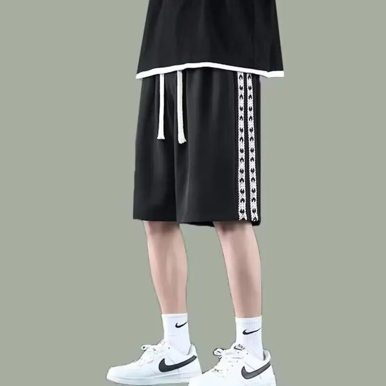 Men's loose-fit track pants in black polyester with micro-elastic fabric and sports styling