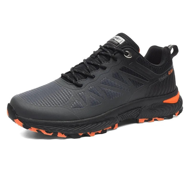 Men's black and orange mesh outdoor running shoe with round toe and flat heel on a rubber sole.