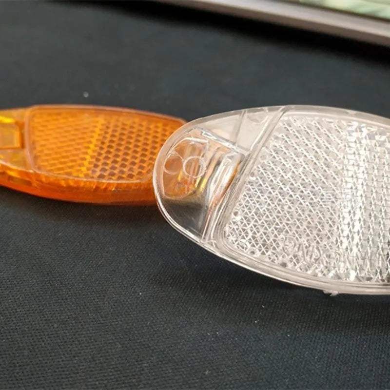 Yellow and white plastic bicycle spoke reflectors for front and rear wheel safety