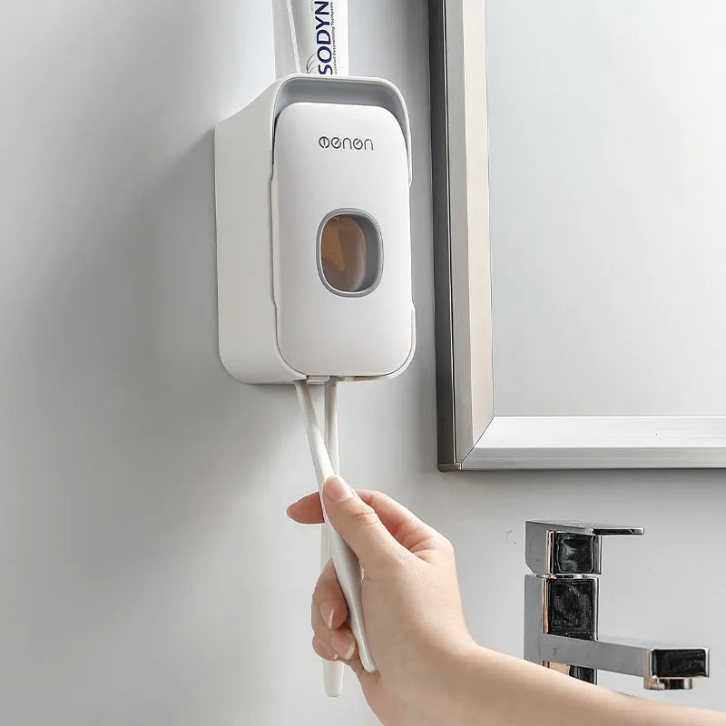 Automatic touchless toothpaste dispenser in blue colour mounted on a bathroom wall.