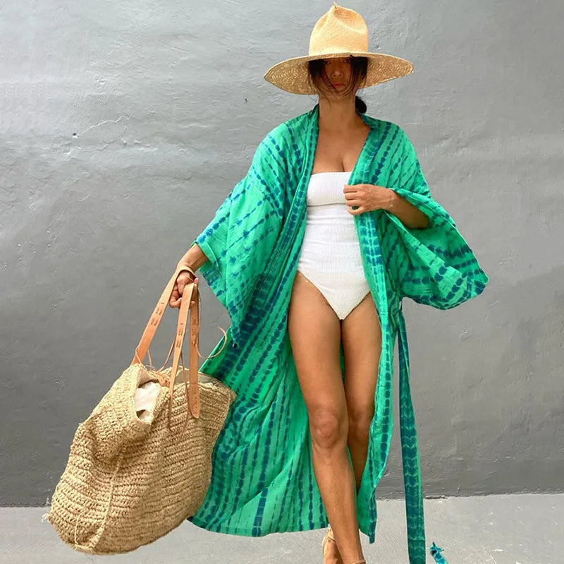 Woman wearing a printed cotton beach cover-up blouse in a DN0712 series colour.