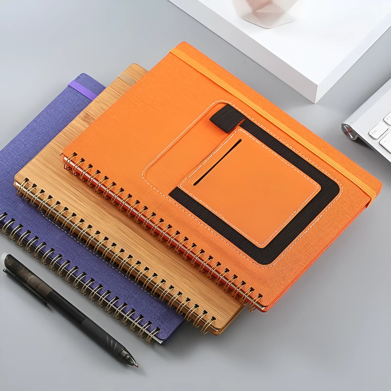 Erasable spiral notebook with stone paper in choice of cover colours, featuring optional pockets or sticky notes