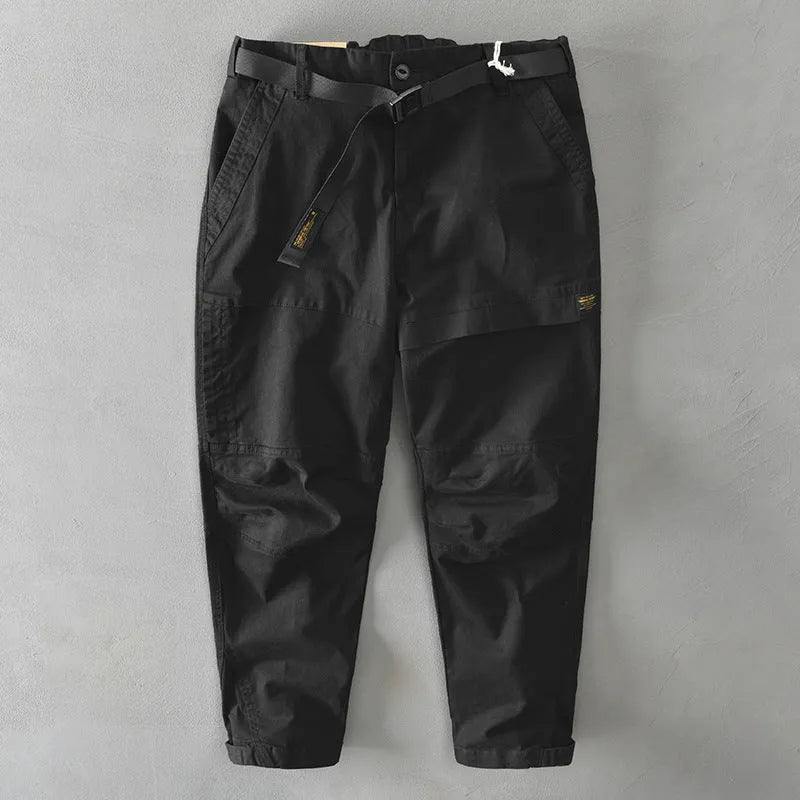 Men's khaki coloured loose-fit casual overalls with an elastic waistband on a hanger.