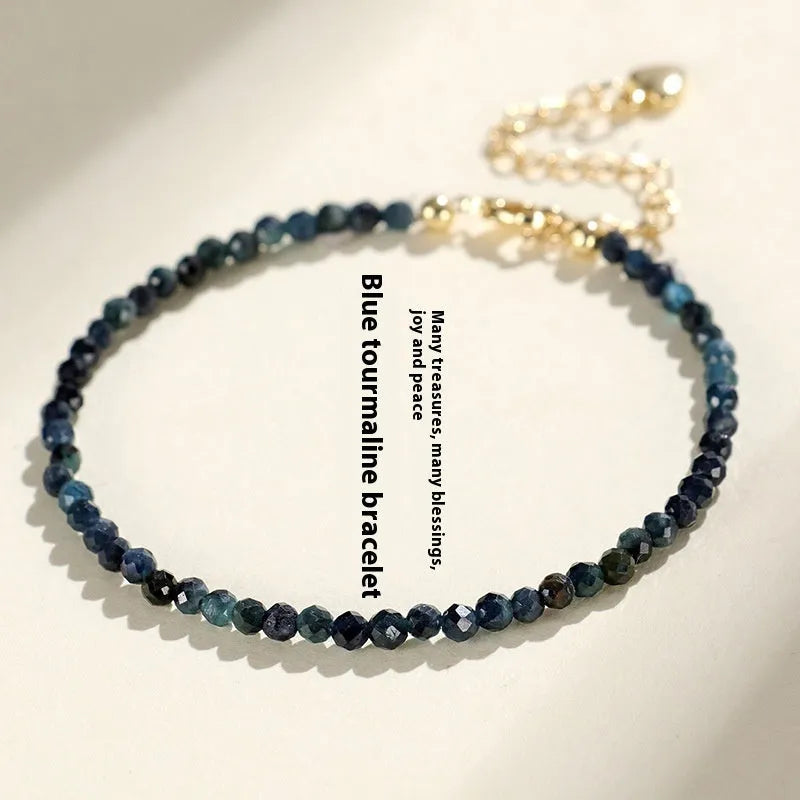 Blue tourmaline spacer bead bracelet with 3mm cut beads and blue gold accents