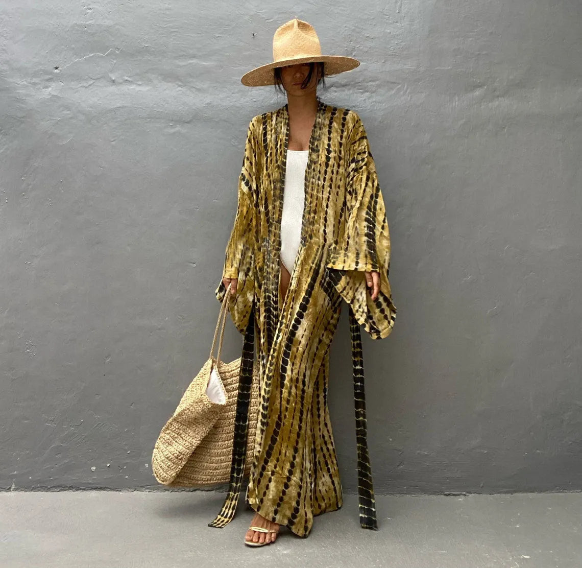 Woman wearing a printed cotton beach cover-up blouse in a DN0712 series colour.