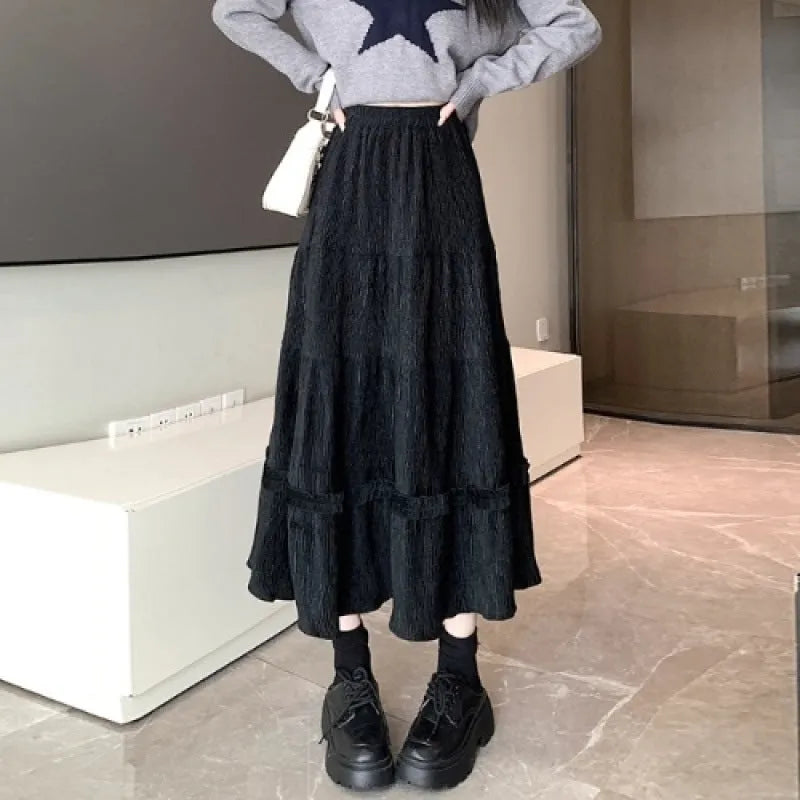 Corduroy A-line midi skirt with elastic waistband in beige, black or brown colours showing Korean style slimming silhouette