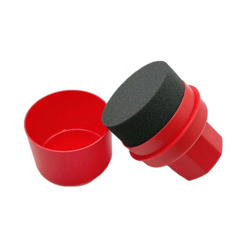 Black and red tyre polishing sponge brushes with lids on a surface, showing hand-held design and sponge options.