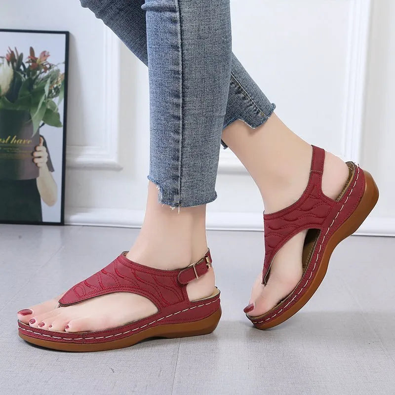 Women's casual wedge heel flip flop sandals with an adjustable buckle strap in black.