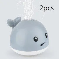 Automatic water spray whale bath toy with colourful LED lights floating in baby bath