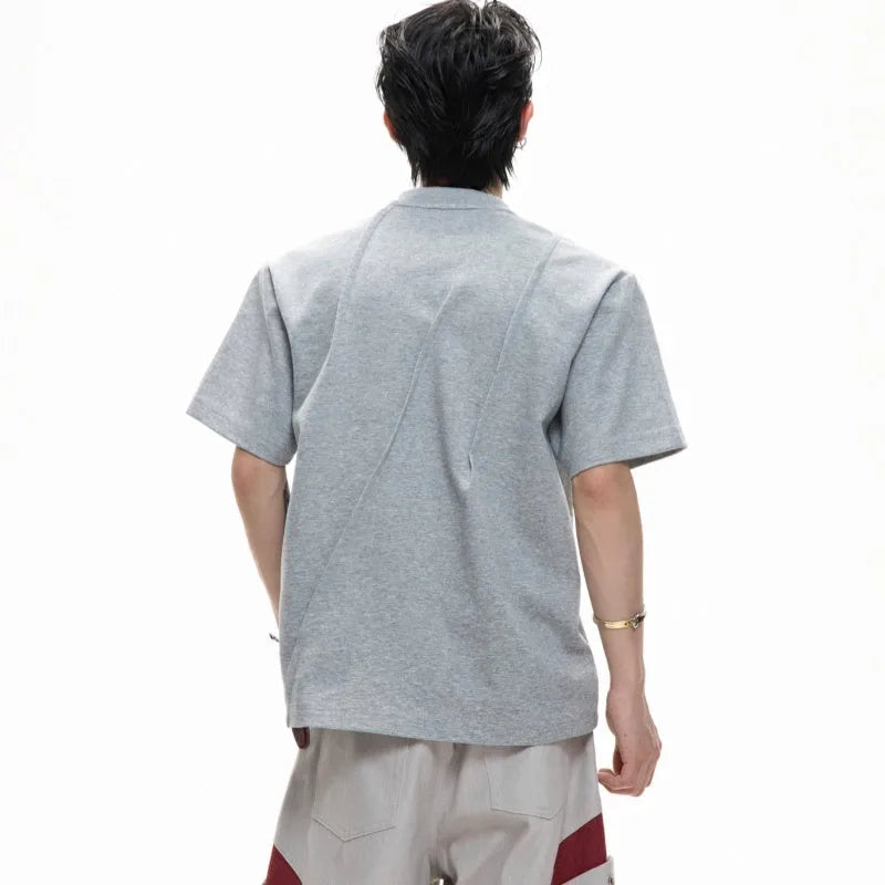 Men's loose fit grey cotton T-shirt with three-dimensional pleating detail on the front.