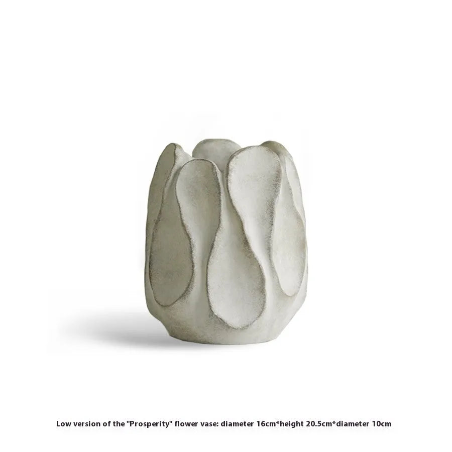 Handmade irregular shaped ceramic vase in natural glaze on a wooden surface.