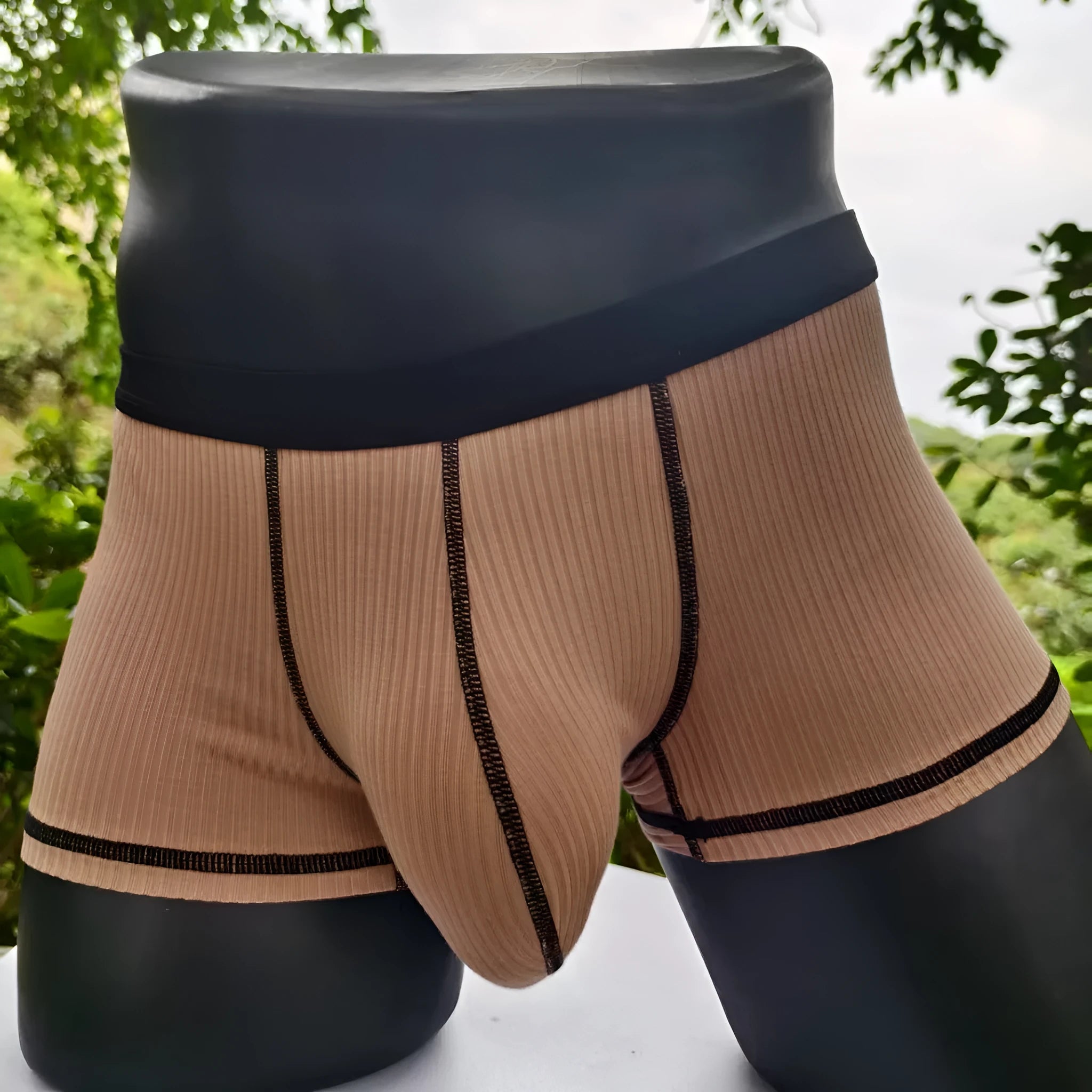 Men's solid colour boxer shorts on a white background, showing thin breathable fabric.