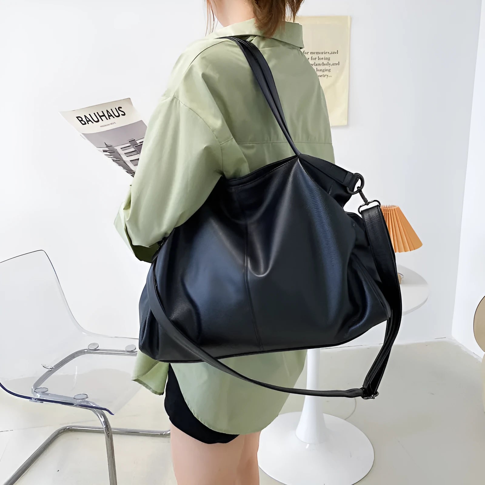 Large soft PU leather messenger bag in khaki colour with adjustable shoulder strap and top handle.