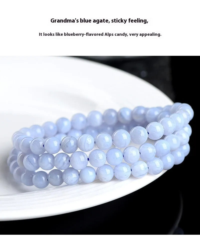 Blue agate bracelet with natural striped pattern and scattered bead design featuring Ruyi elements
