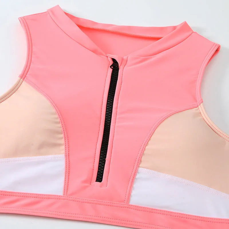 Pink high-waist bikini set with sleeveless top and split-leg shorts on a mannequin.