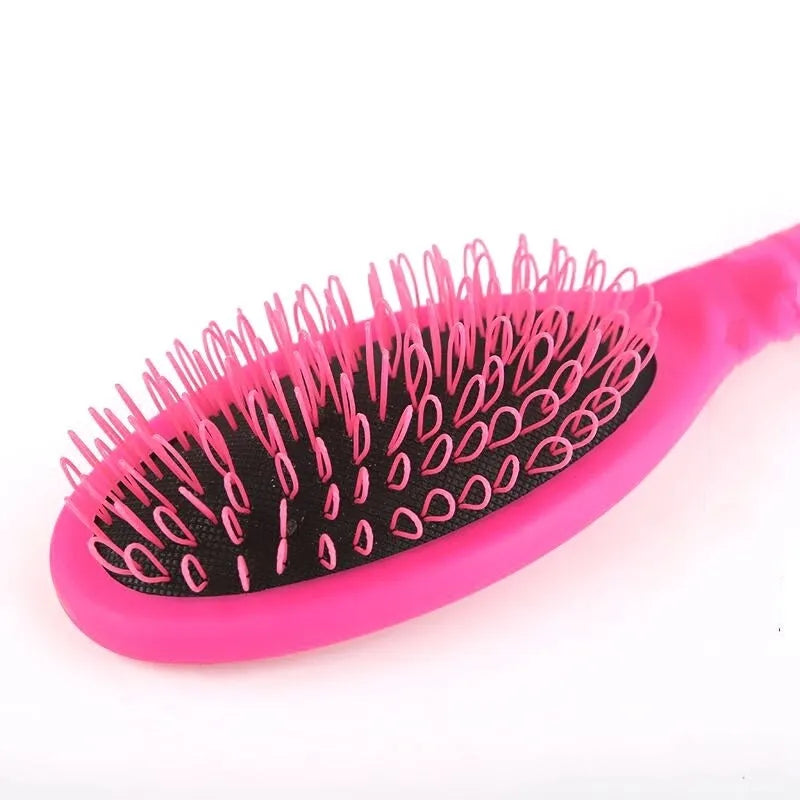 Ring tooth hair extension comb with airbag design measuring 22cm by 6cm in black or pink ABS plastic