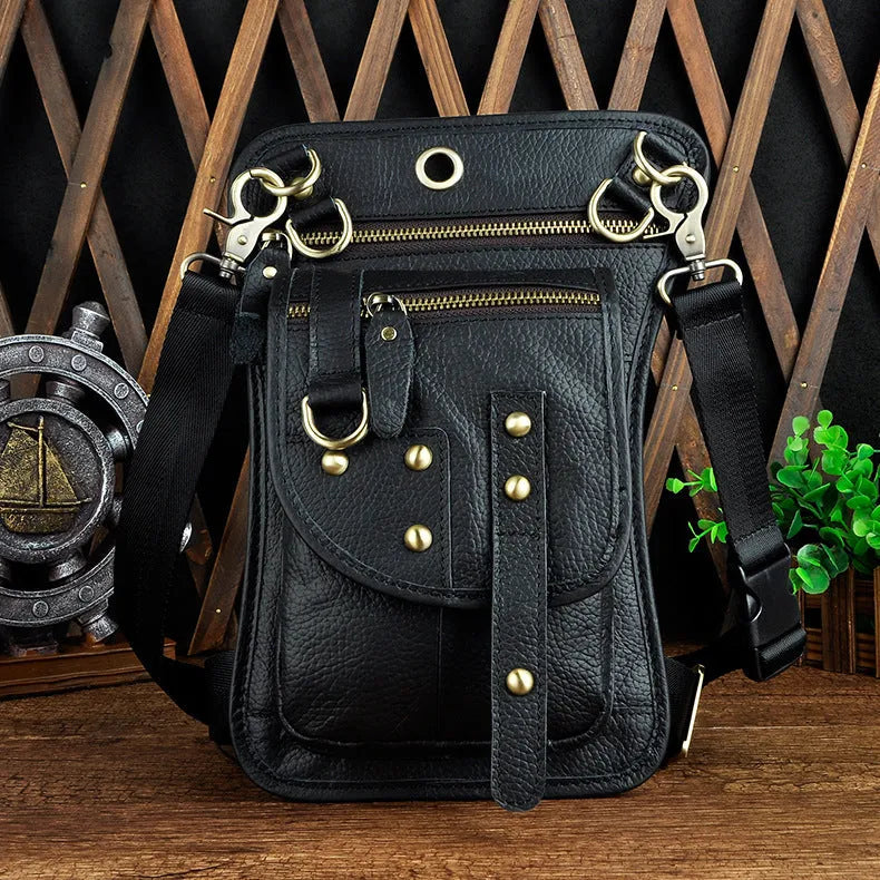 Small black genuine leather men's punk-style fanny pack worn on waist with zipper open