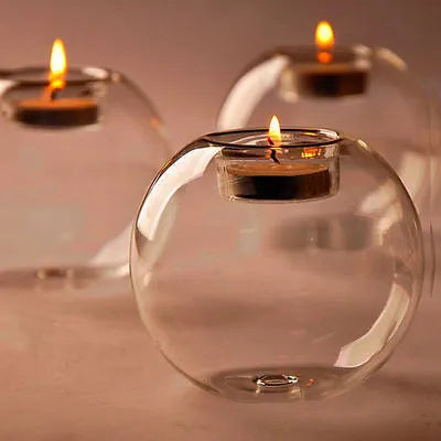 Handmade round transparent glass candle holder showing hollow centre for a candle