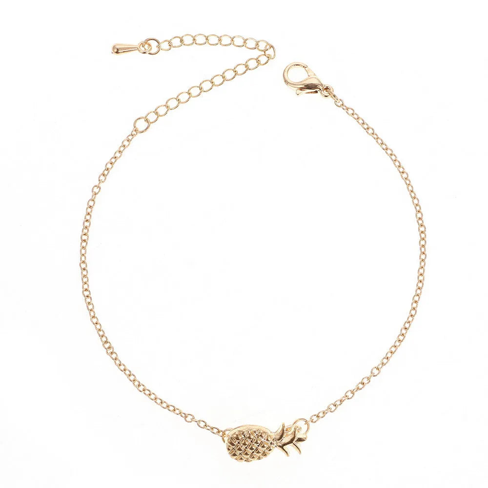 Women's alloy pineapple bracelet on wrist, showing B178 gold or silver finish and fruit-shaped design.