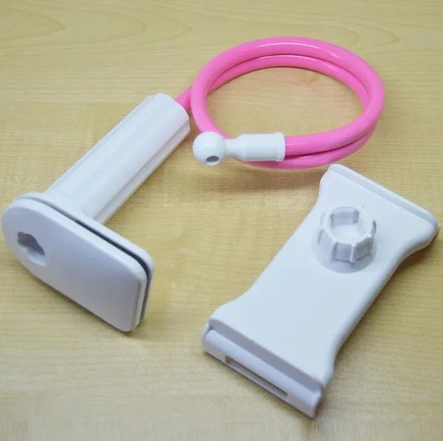 Black aluminium alloy phone holder with flexible arm on a wooden table holding a mobile phone.