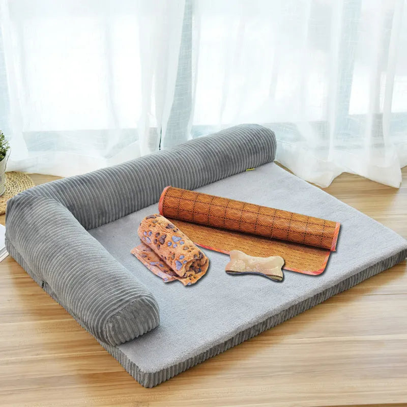 Corduroy dog sofa bed in grey, showing high sides and non-slip base, placed on a wooden floor.