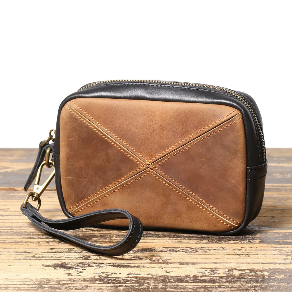 Unisex retro brown genuine leather messenger bag with artistic stitching and horizontal square shape on a plain background