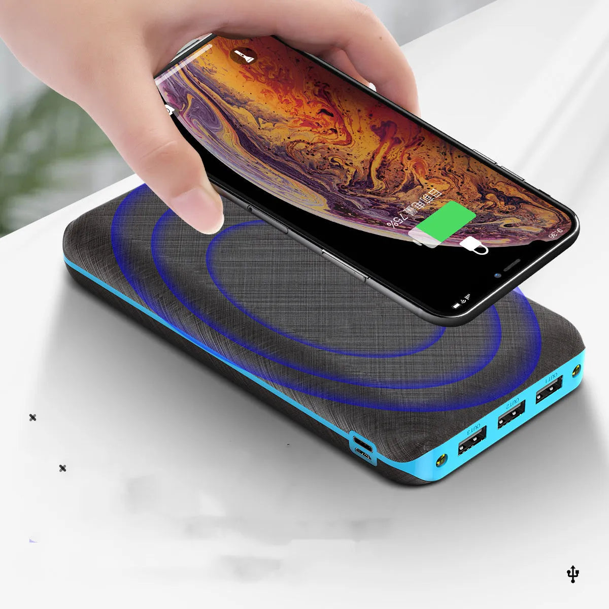 Black wireless solar power bank with Qi charging pad, three USB ports and an LED flashlight