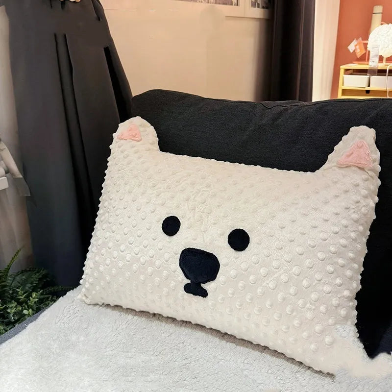 Grey or white West Highland puppy shaped pillow on a sofa, 50cm long.