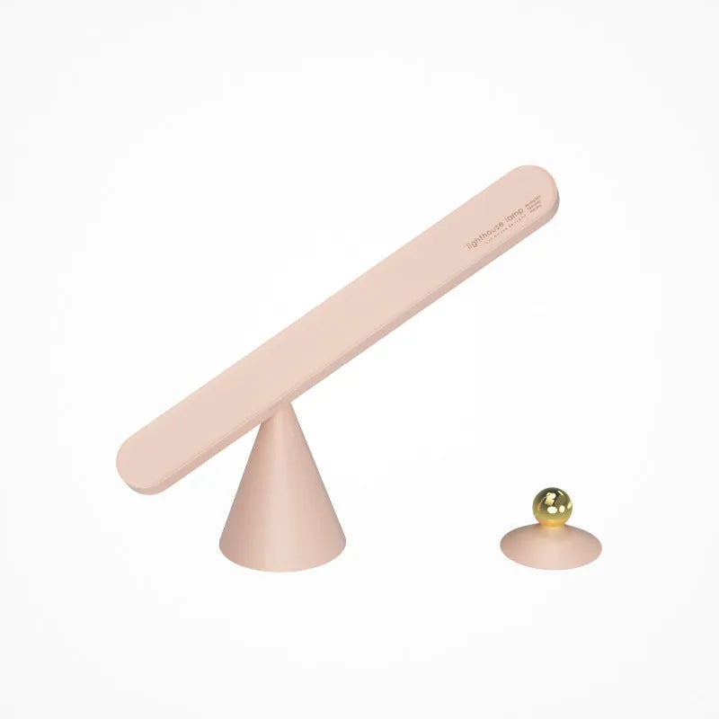 White geometric USB desk lamp with magnetic base shown on a wooden desk.