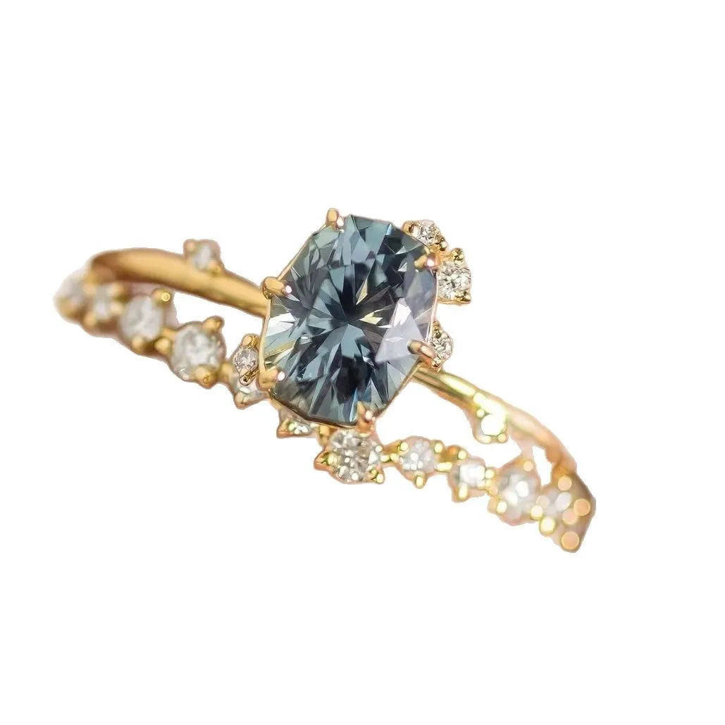 Gold-plated women's ring with green zircon stone in floral design, showing detailed metalwork and stone setting