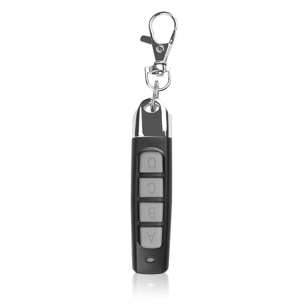 A compact black rolling door remote control measuring 6.7cm, showing buttons for copying and operation.