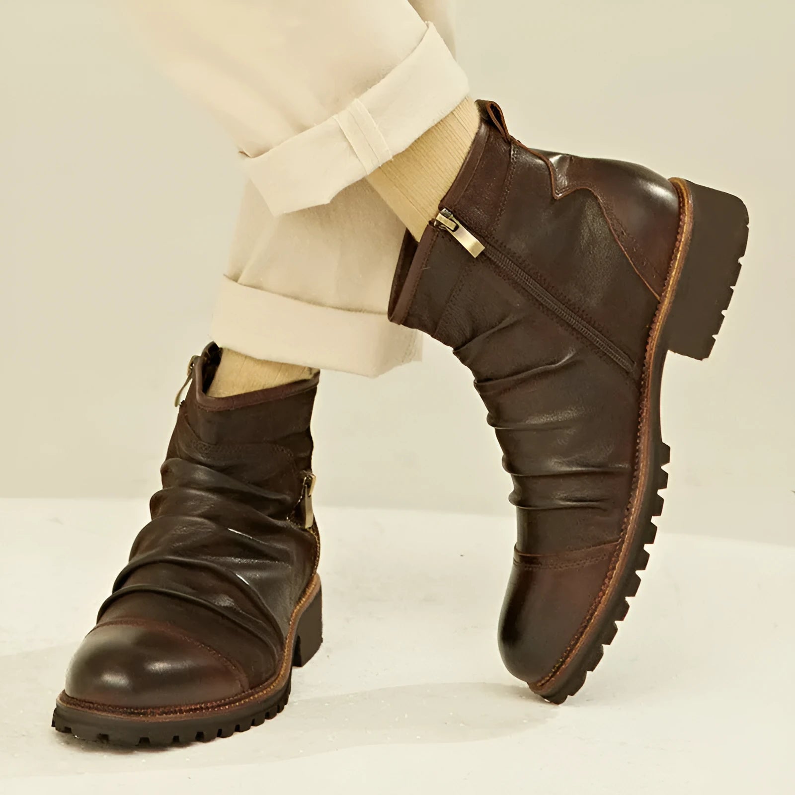 Black side zip Martin boots with round toe and medium heel on a plain background.